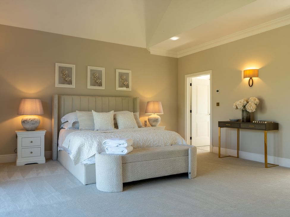 A bedroom with a bed and bedside tables at Sea Estate House in Rustington