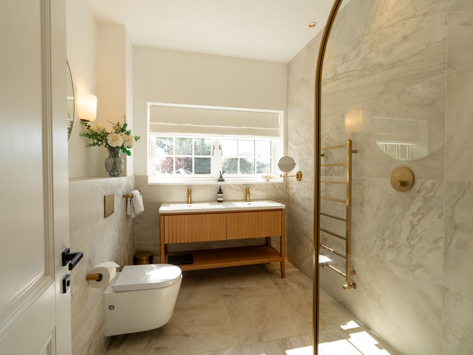 A bathroom with a sink, shower, and toilet at Sea Estate House, Rustington