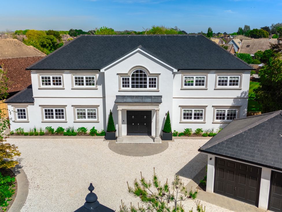 A house with a driveway and garage at Sea Estate House in Rustington