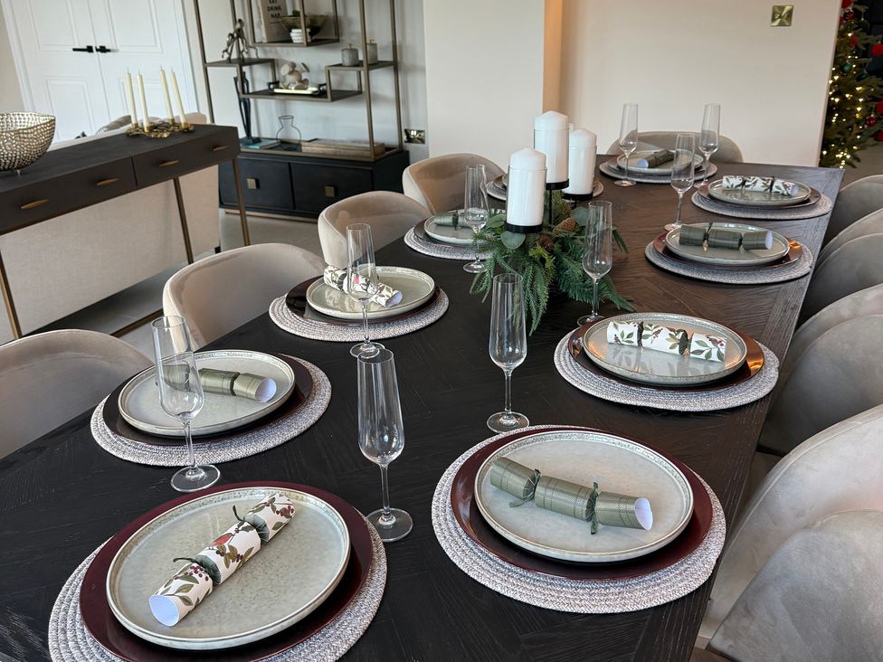 A dining room set for a meal at Sea Estate House in Rustington