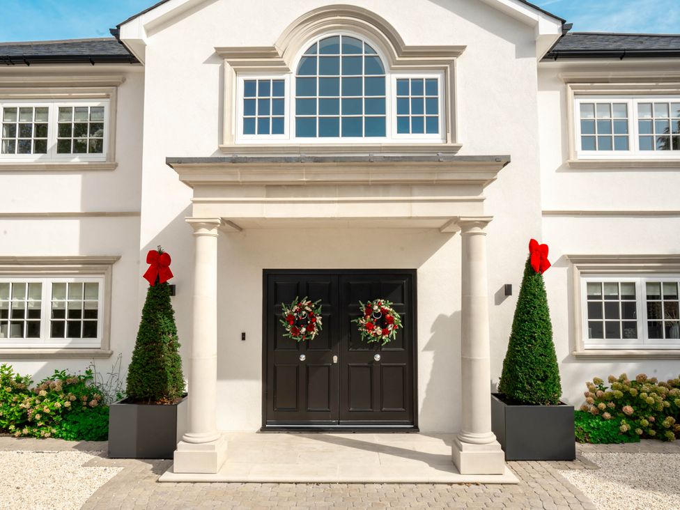 A front entrance with a double door and wreaths at Sea Estate House in Rustington