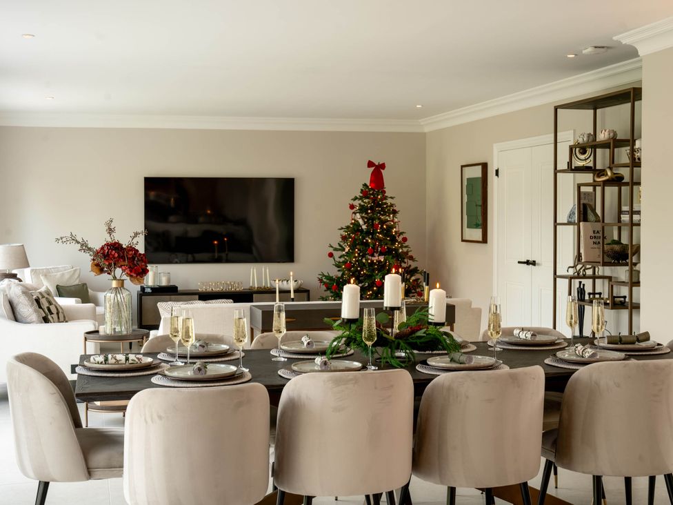 A dining room with a table and chairs at Sea Estate House in Rustington