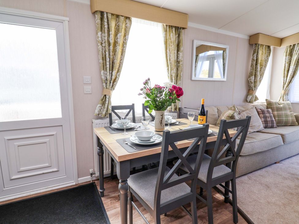 A dining area with table and chairs at The Retreat in Prestatyn