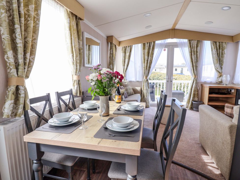 A dining room with a table set for a meal at The Retreat in Prestatyn