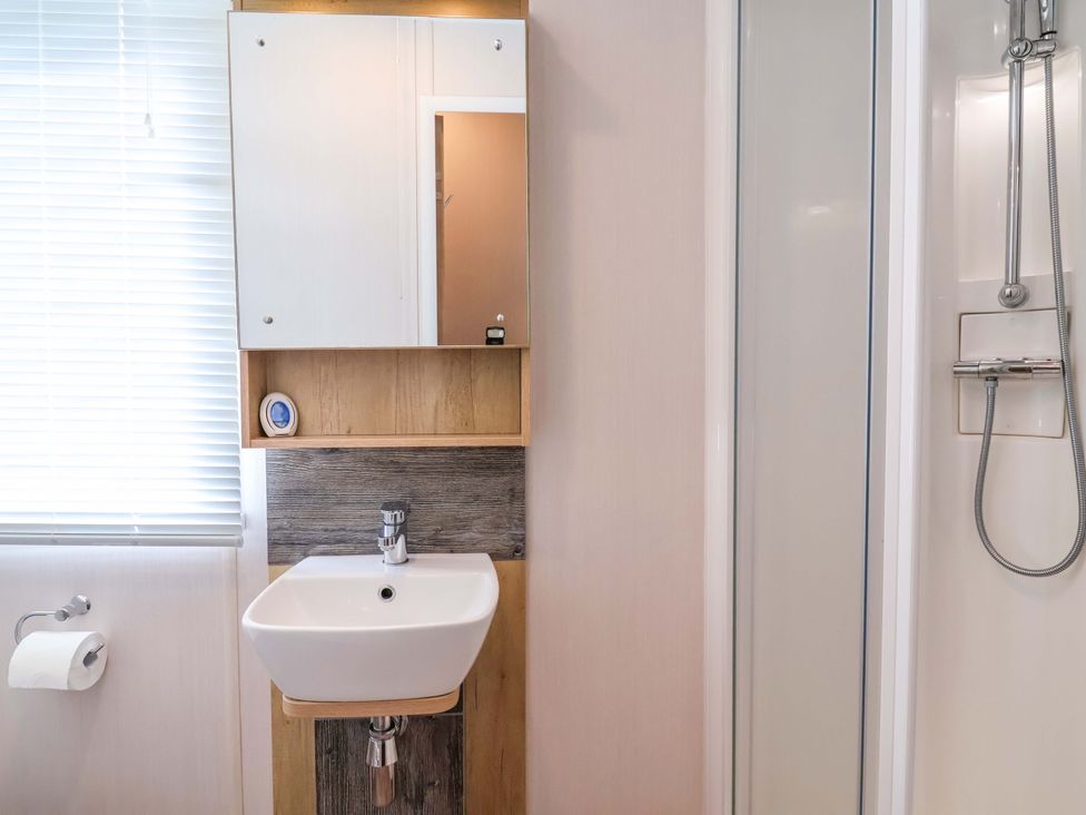 A bathroom with a sink and mirror at The Retreat in Prestatyn