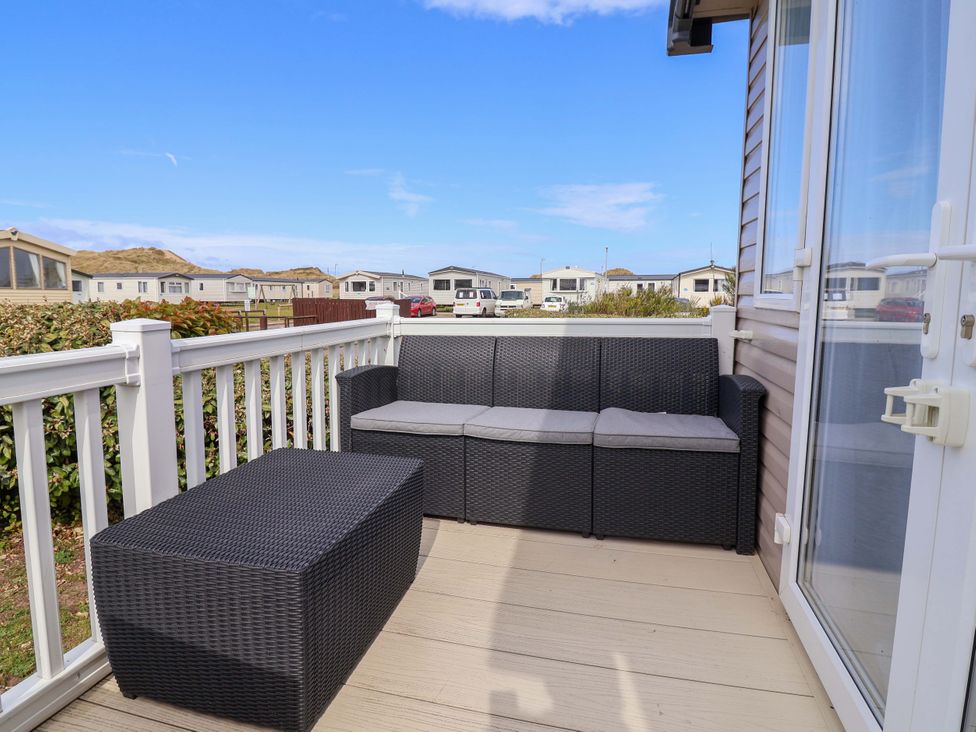 An outdoor seating area with a sofa and coffee table at The Retreat in Prestatyn