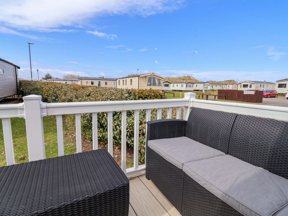 An outdoor seating area with a sofa and coffee table at The Retreat in Prestatyn