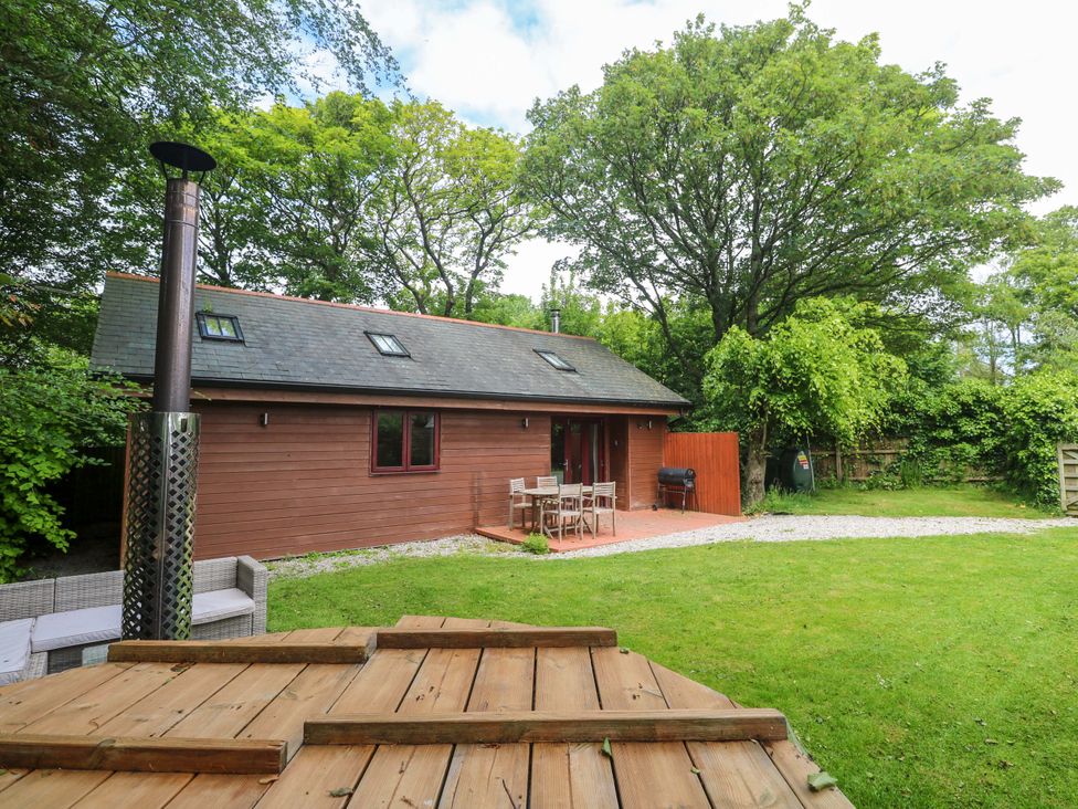 A house with patio furniture and a chimney at The Lodge at Lamburn
