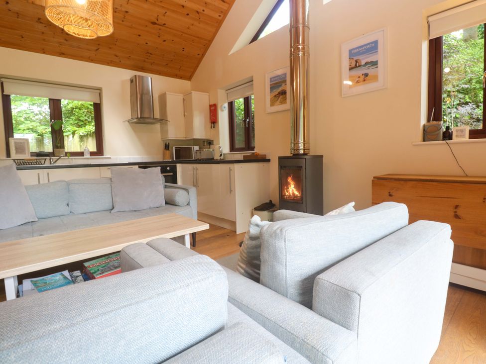 A living room with a wood stove and sofa at The Lodge at Lamburn