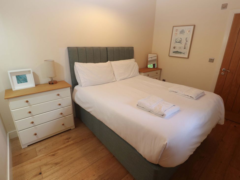 A bedroom with a bed and dresser at The Lodge at Lamburn