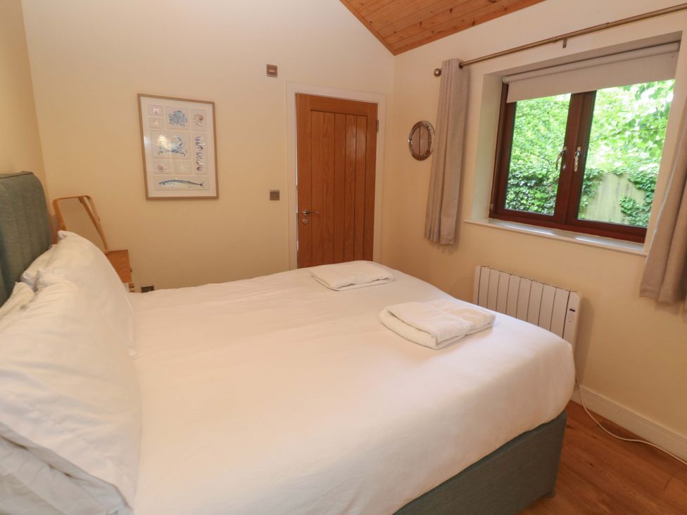 A bedroom with a bed and window at The Lodge at Lamburn