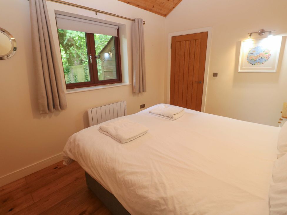 A bedroom with a bed and window at The Lodge at Lamburn