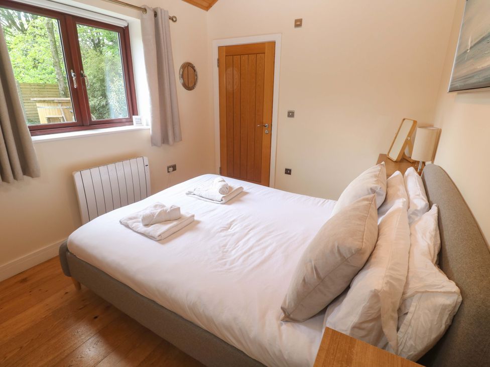 A bedroom with a bed and window at The Lodge at Lamburn