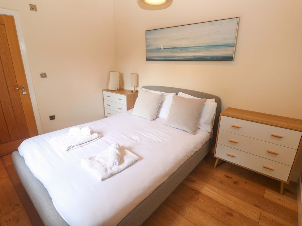 A bedroom with a bed and bedside tables at The Lodge at Lamburn