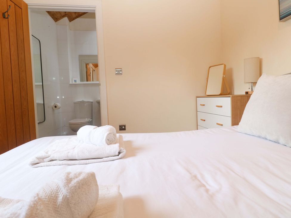 A bedroom with a bed and dresser at The Lodge at Lamburn