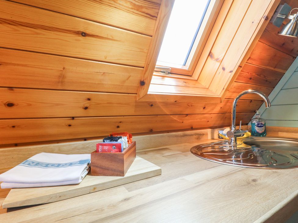 A kitchen with a sink and wooden countertop at Skylark in Loughborough