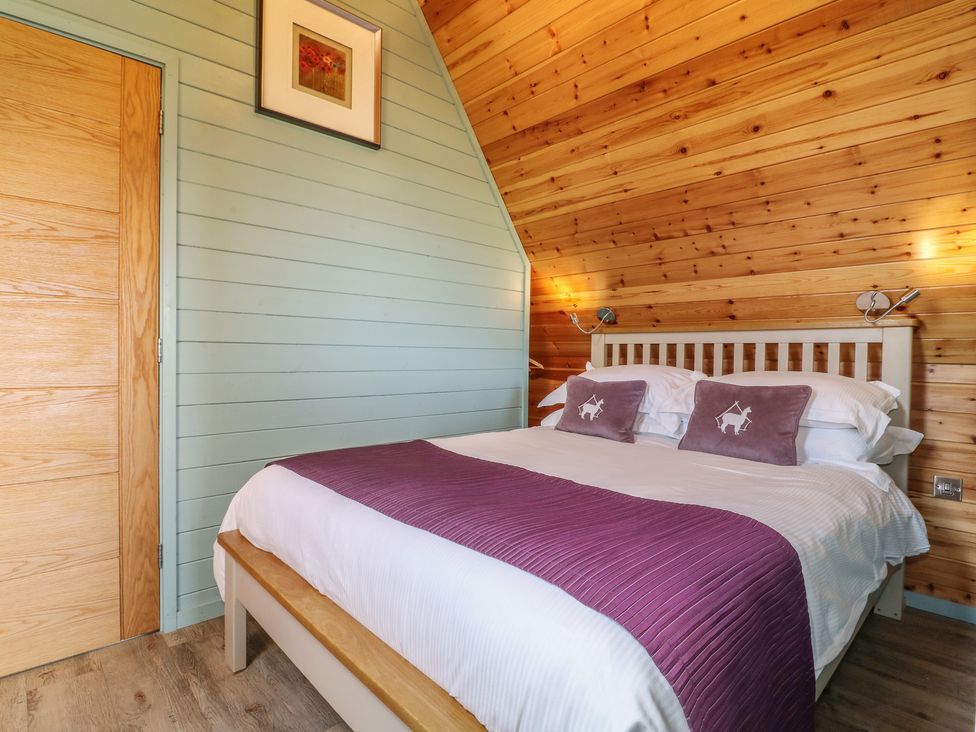 A bedroom with a bed and a door at Skylark in Loughborough