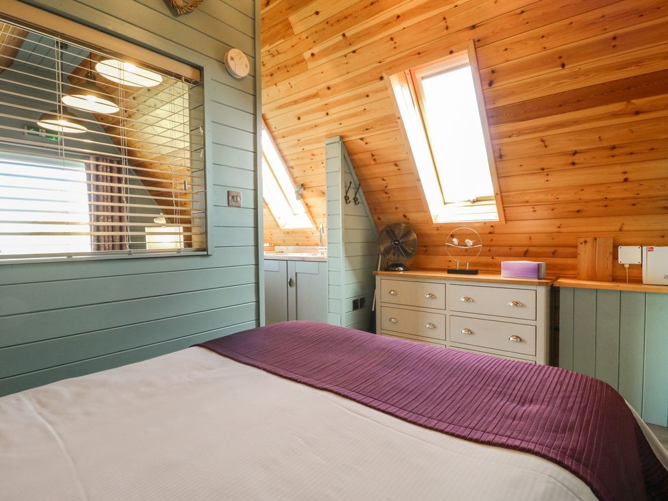 A bedroom with a bed and a fan at Skylark in Loughborough