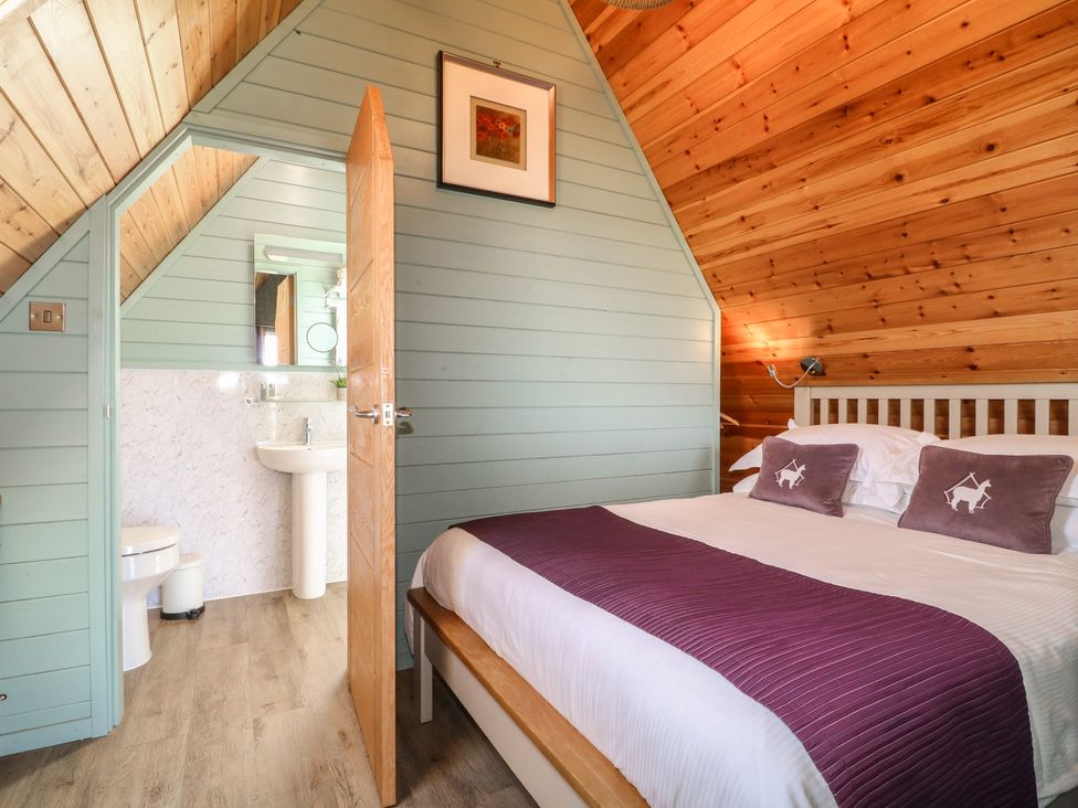 A bedroom with a bed and adjoining bathroom at Skylark in Loughborough