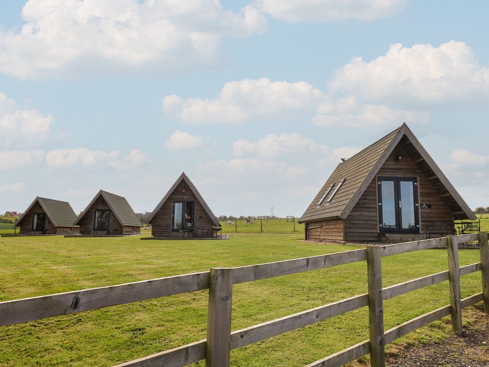 Four cabins on a grassy area at Skylark in Loughborough