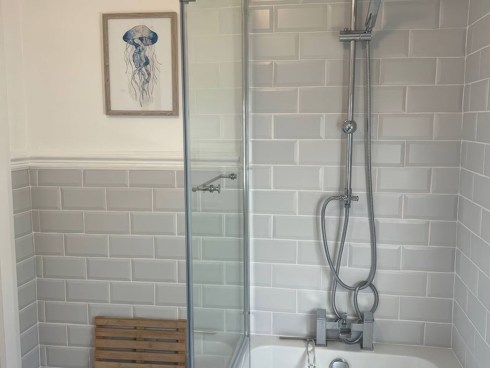 A bathroom with a shower and bathtub at 3 Newboro Terrace in Conwy