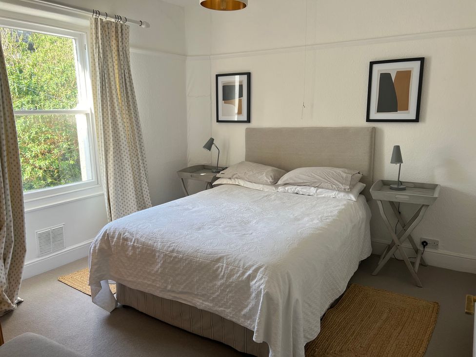 A bedroom with a bed and bedside tables at 3 Newboro Terrace in Conwy