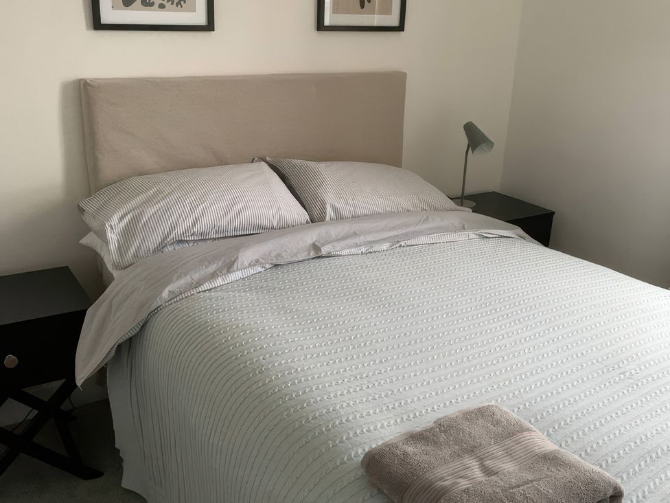 A bedroom with a bed and bedside table at 3 Newboro Terrace in Conwy