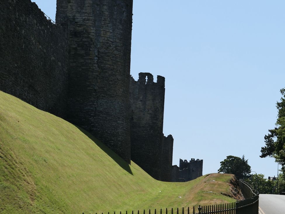 Castle wall with towers and grass area at 3 Newboro Terrace in Conwy