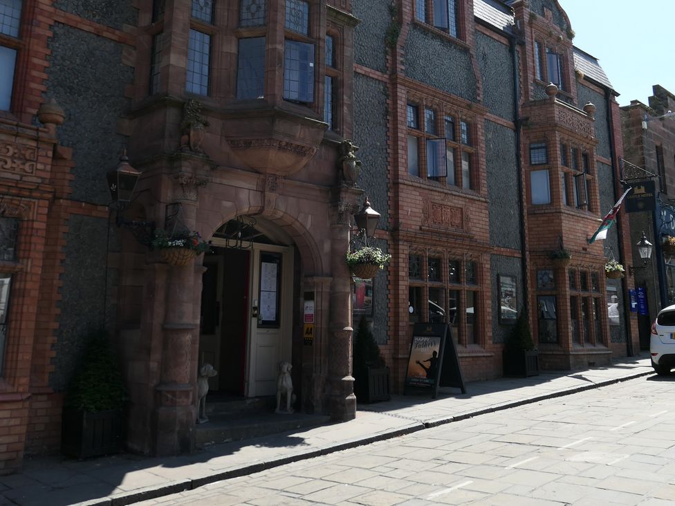 A building entrance with windows and planters at 3 Newboro Terrace in Conwy