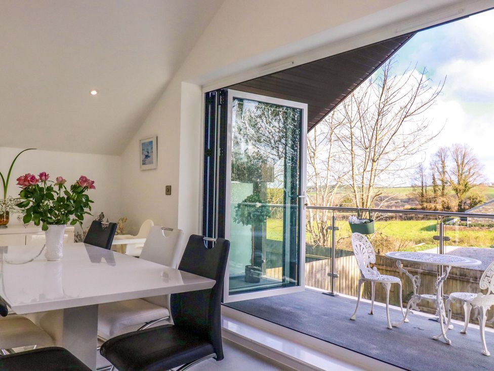 A dining room with a table and chairs at Meadow Retreat in Bodmin
