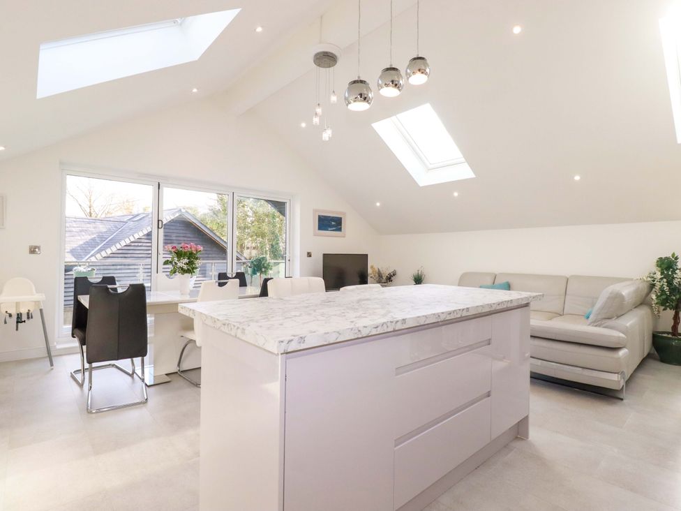 A kitchen with an island and dining area at Meadow Retreat in Bodmin