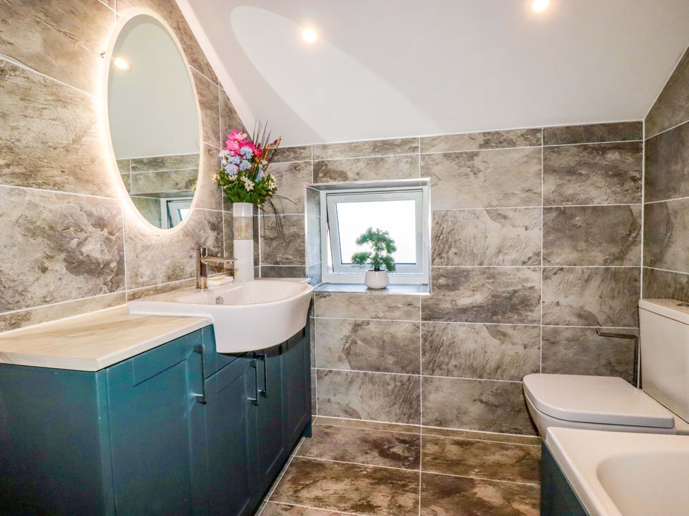 A bathroom with a sink and toilet at Meadow Retreat in Bodmin
