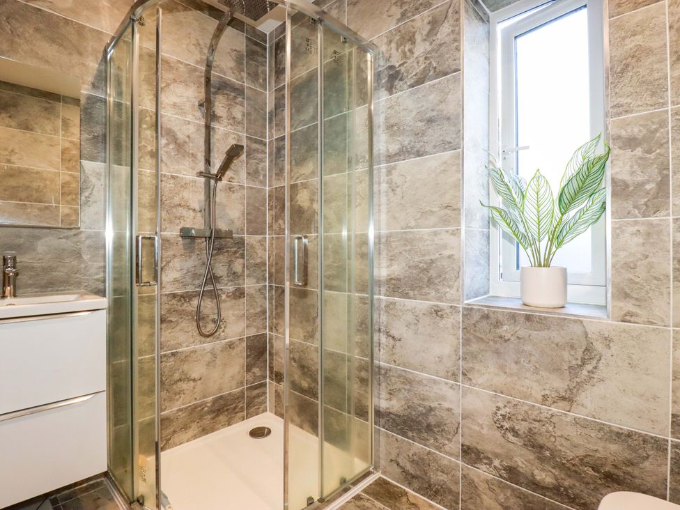 A bathroom with a shower and sink at Meadow Retreat Bodmin