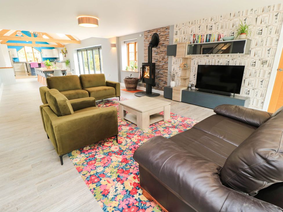 A living room with sofas and a fireplace at Hazeldene near Harvington
