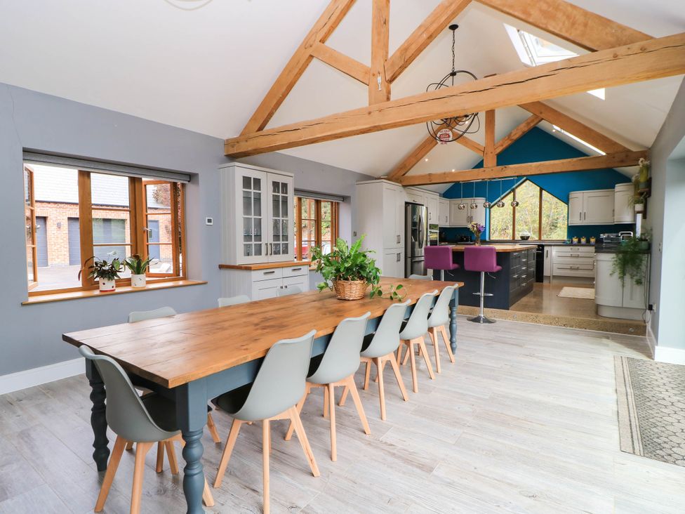 A kitchen with a dining table and chairs at Hazeldene near Harvington