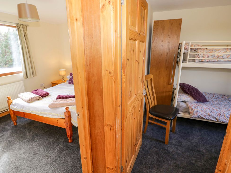 A bedroom with a bed and bunk bed at Lavender Lodge Evesham