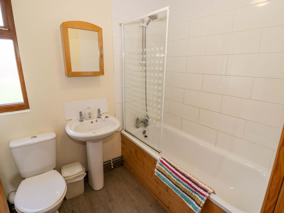 A bathroom with a shower and bathtub at Lavender Lodge Evesham
