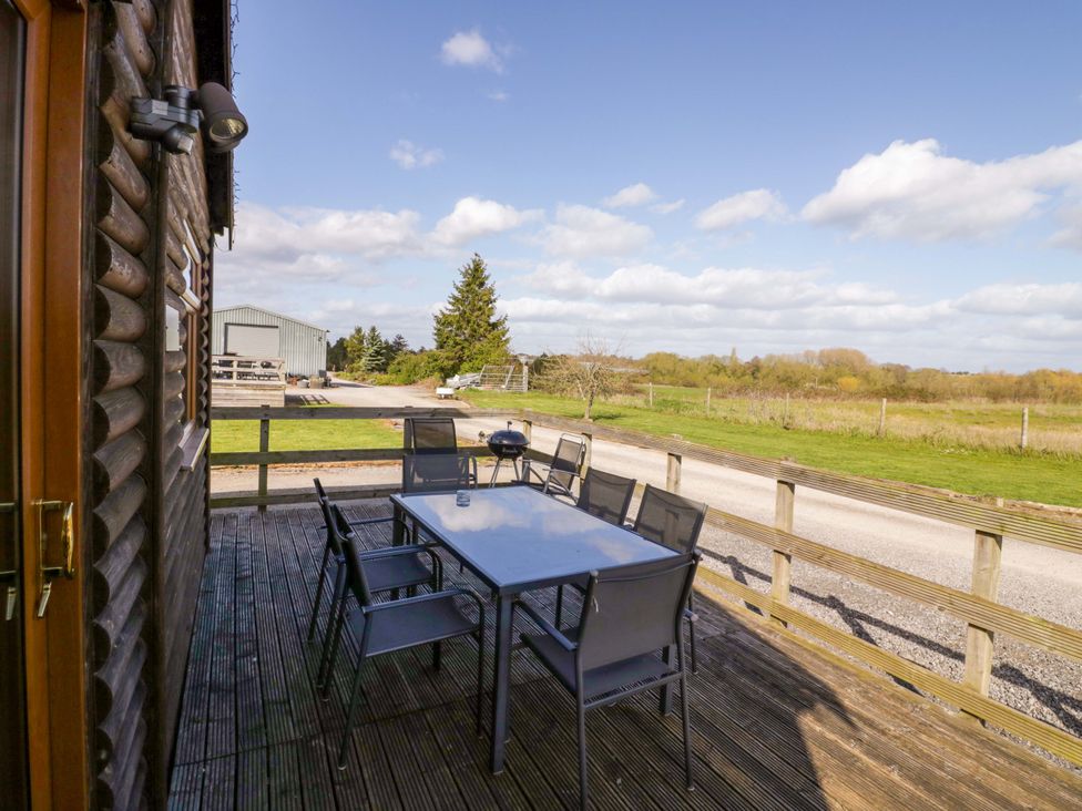 A patio with a table and chairs at Lavender Lodge in Evesham