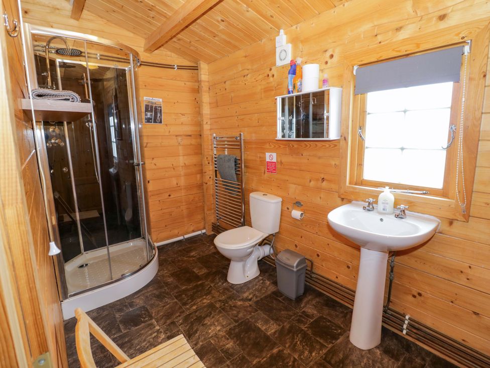A bathroom with a shower and sink at Holly Lodge in Evesham