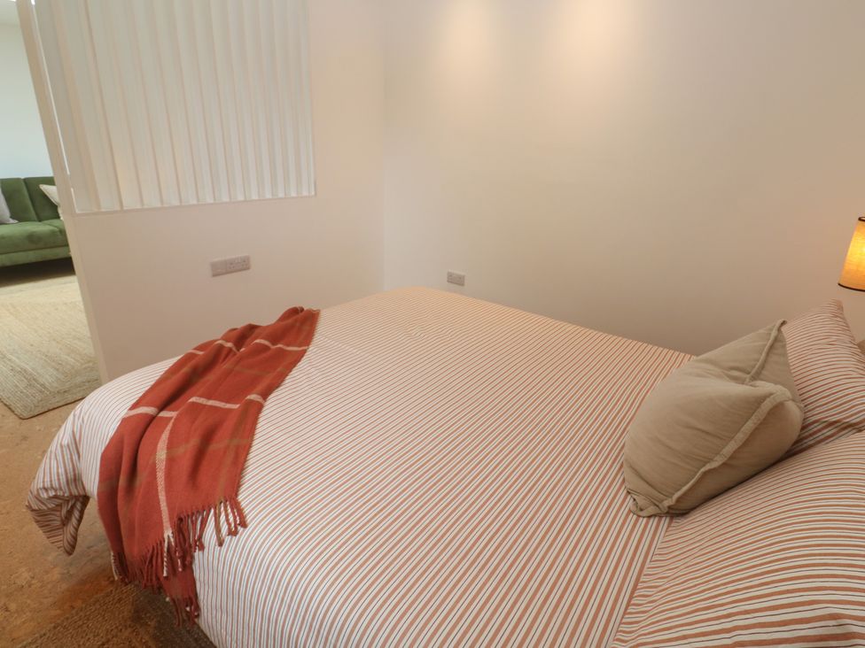 A bedroom with a bed and lamp at Birdsong in Gulval