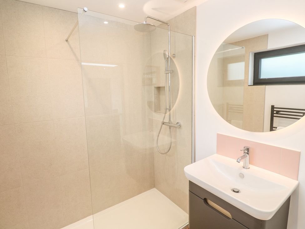 A bathroom featuring a shower, sink, and mirror at Birdsong in Gulval