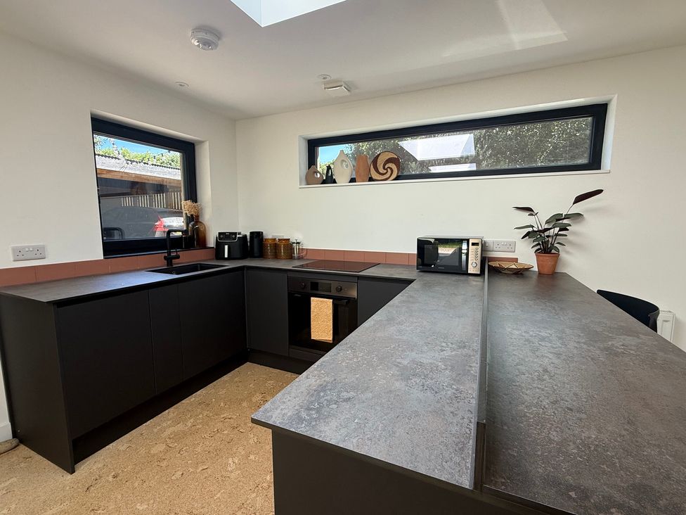A kitchen with counter and appliances at Birdsong in Gulval