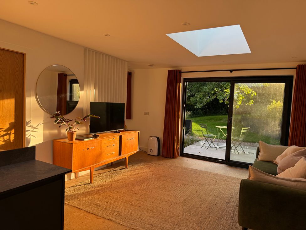 A living room with a television and a coffee table at Birdsong in Gulval