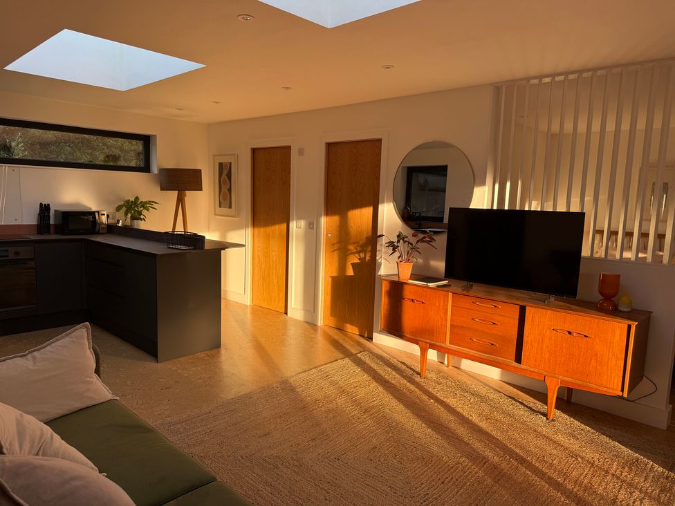 A living room with furniture including a television and a sofa at Birdsong in Gulval