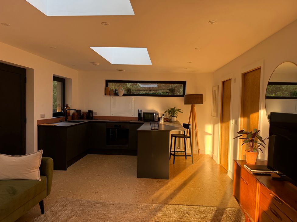 A kitchen with a stove and microwave at Birdsong in Gulval