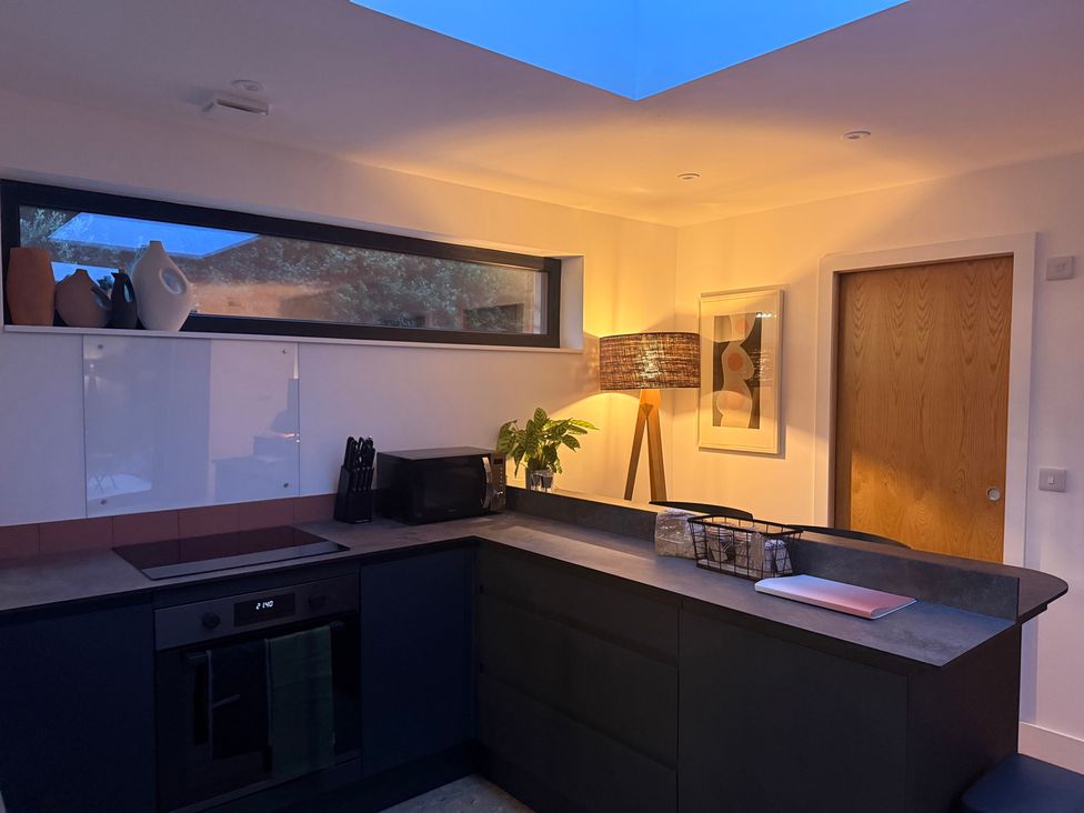 A kitchen with a cabinet and microwave at Birdsong in Gulval