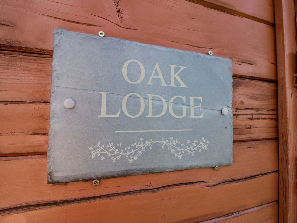 A sign for Oak Lodge on a wooden surface at Oak Lodge Offenham