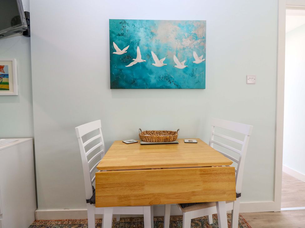 A dining room with a table and chairs at The Lighthouse Bothy in St Abbs