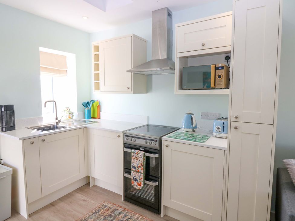 A kitchen with appliances and storage at The Lighthouse Bothy in St Abbs