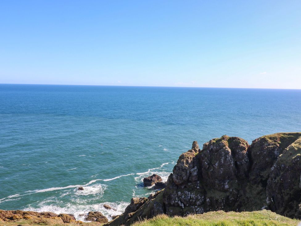 A view of the ocean and cliffs at The Lighthouse Bothy in St Abbs